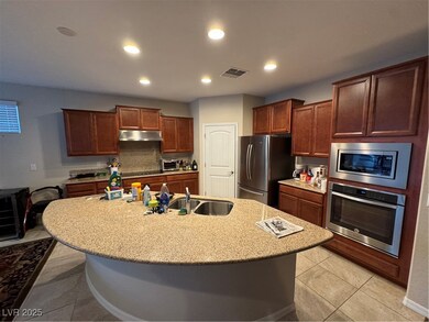 Kitchen featuring oven, refrigerator, exhaust hood