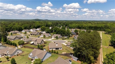 Birds eye view of property featuring a wooded view