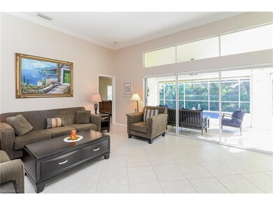 Living space overlooking covered lanai and pool ar
