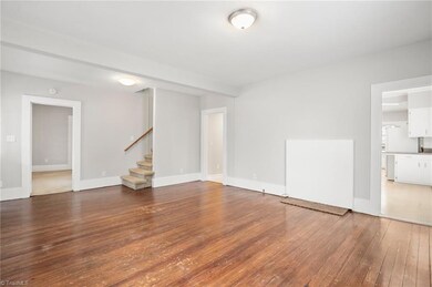 Living room view to stairway in hallway