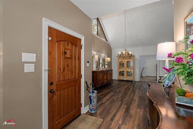 Foyer entrance with high vaulted ceiling, a notabl
