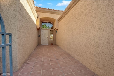 Property entrance featuring a tiled roof, a gate,