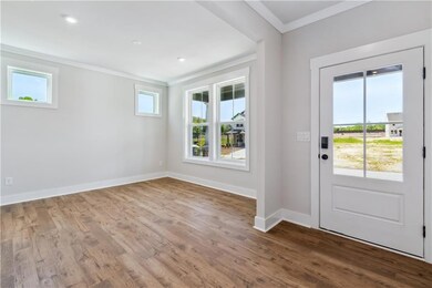 Entryway and dining area featuring baseboards, cro
