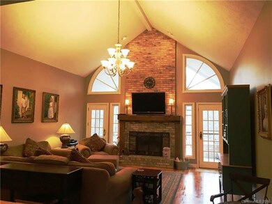 Great room w/ brick fireplace, vaulted ceilings & 