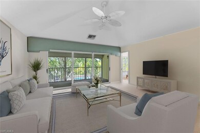 Carpeted living room with vaulted ceiling and ceil