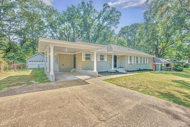 Ranch-style home featuring a garage, a front lawn,
