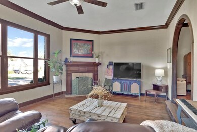 Living room with ceiling fan, wood-type flooring, 