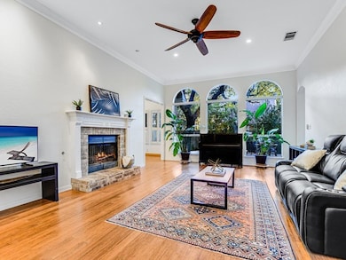 Living area with ceiling fan, a brick fireplace, 