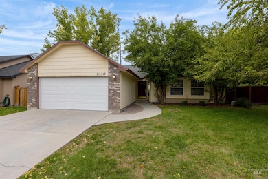 View of front of home featuring brick siding, driveway, and an attached garage