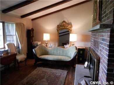 Living Room Wood beams, floors & double sided bric