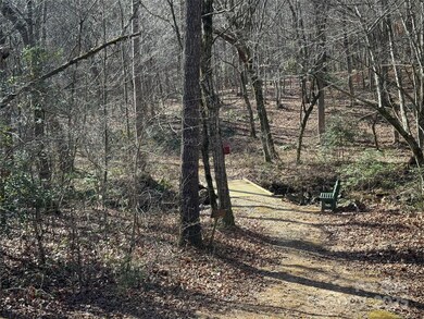 Walking trail with bridge over creek and bench