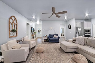 Living area with wood finished floors and ceiling fan