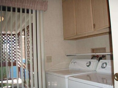 Laundry room with patio access.