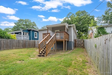 Rear view of property featuring a fenced backyard,
