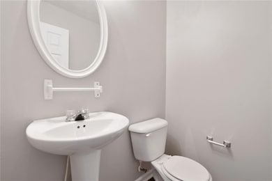 Bathroom featuring toilet and baseboards