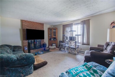 The welcoming great room features a floor-to-ceili