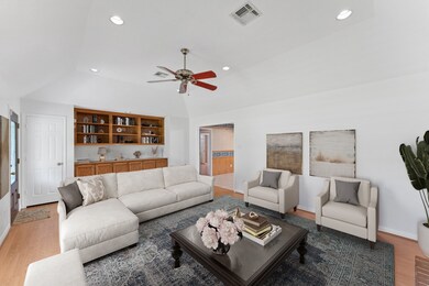 The living room also has built-in shelving and cab