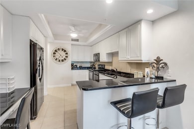Kitchen with a raised ceiling, appliances with sta