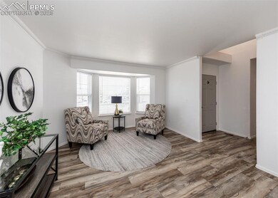 Living area featuring wood finished floors, orname
