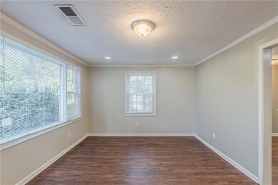 Empty room with baseboards, a textured ceiling, vi