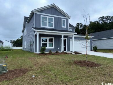 View of front of house featuring a porch, a garage