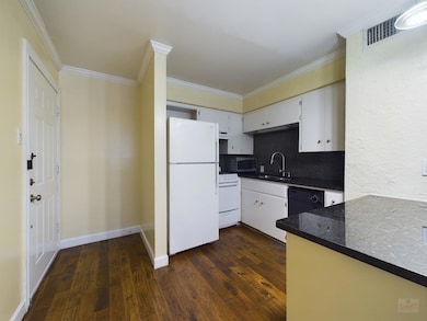 Kitchen with visible vents, ornamental molding, a