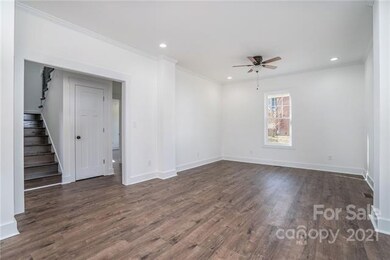 Stairwell to upstairs and hall to primary suite