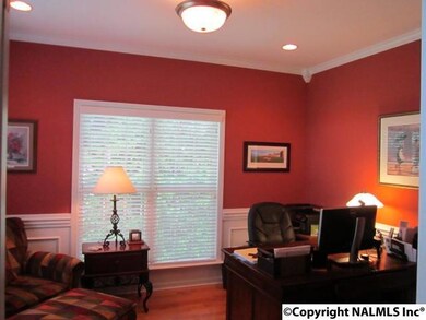 The Dining Room/Study welcomes you with French doors, hardwoods, wainscoting, recessed lighting, and  crown moulding.