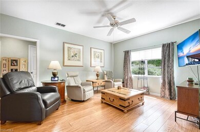 Living room featuring light wood-type flooring and ceiling fan