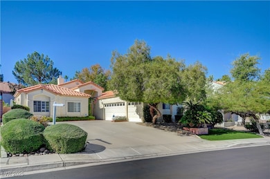 View of front of property with driveway, stucco siding, a chimney, a garage, and a tile roof