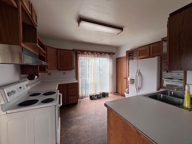 Kitchen with sink, wall chimney exhaust hood, and 