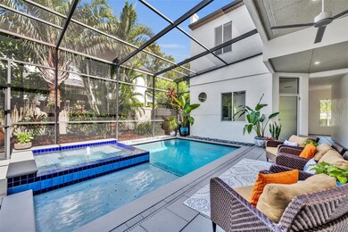 The screened-in courtyard with a heated saltwater pool and spa