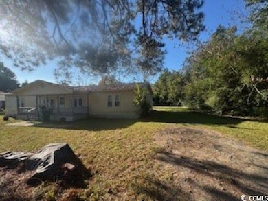 View of grassy yard with a patio area