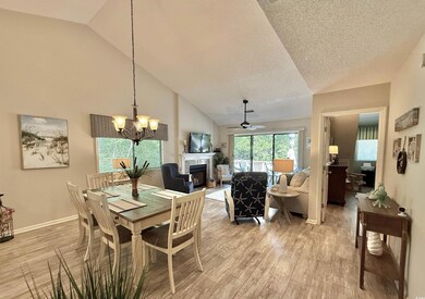 Dining room featuring high vaulted ceiling, a text