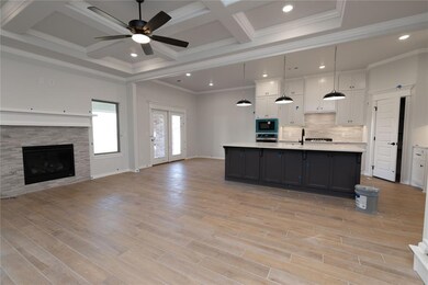 Kitchen with built in microwave, white cabinetry, 