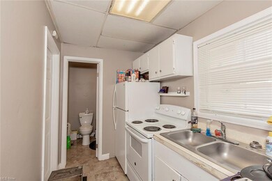 Efficiency unit kitchen with view of bathroom