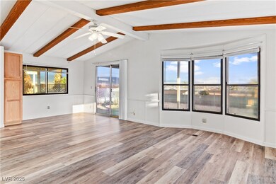 Living room with vaulted ceiling with beams, ceili