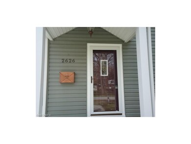 Newer siding, front door, storm door and columns.