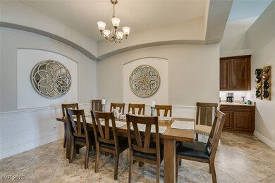 Dining room with a chandelier and light tile patte