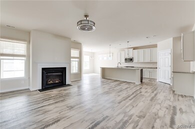 Unfurnished living room featuring sink, a healthy
