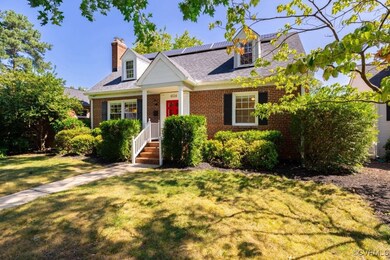 New england style home with a front lawn