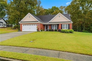 View of front facade with driveway, brick siding, an attached garage, a shingled roof, and a porch