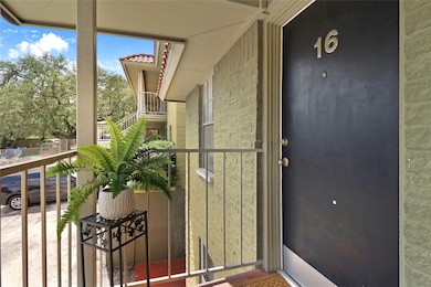 Entrance to property featuring a balcony and a ti
