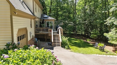 View of green lawn with stairs and a deck