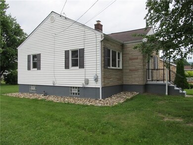 Side of the house, level yard, river rock around p