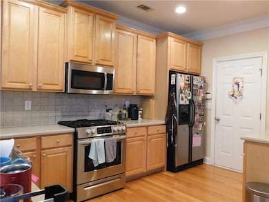 Kitchen featuring stainless steel appliances, crow