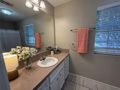 First floor full bathroom with new lighting and cabinets.