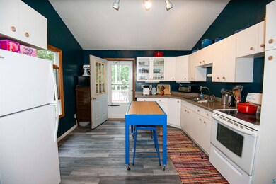 Kitchen featuring sink, lofted ceiling, track ligh