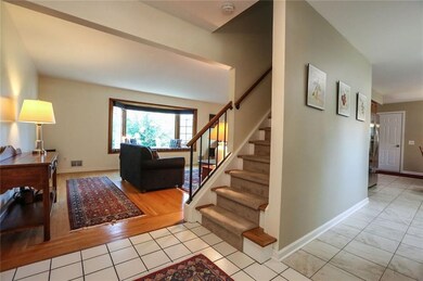 Enter through the double front doors into a bright