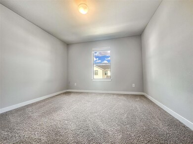 Spare room with carpet and baseboards